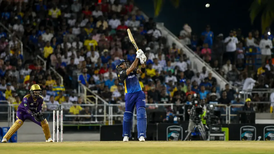A Barbados Tridents batter clears the boundary in a night match at Kensington Oval.