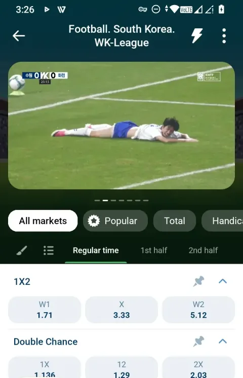 A player down near the touchline while play continues - 1xBet's stream shows the whole match, not a curated reel.